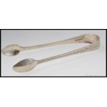 A pair of silver hallmarked sugar tongs with a Birmingham assay mark dated to 1845, 31.