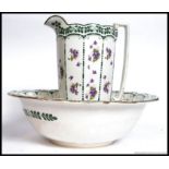 An early 20th century Burleigh Ware chintz pattern large washbowl basin and jug being stamped to