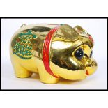 A 20th century Chinese ceramic statue money box in the form of a pig,