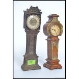 Two vintage 20th century miniature grandfather clocks, both having roman numerals to the face.