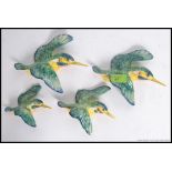 A set of 4 Beswick ceramic Kingfisher wall mounted polychrome figurines. Stamped to verso.