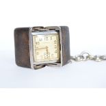 A 1930's Art Deco Sportank silver and snakeskin purse watch complete with white metal albert fob
