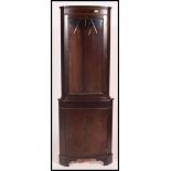 A Regency style mahogany corner cabinet having cupboard to the base with astragal glazed display