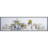 A collection of miniature Staffordshire ceramic tea services to include cups, saucers,