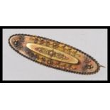 A Victorian 15ct gold ladies oval bar brooch, applied filigree embellishments with gadrooned border.