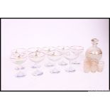 A collection of vintage Babycham glasses ( 8 total ) together with a frosted liqueur decanter and