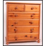 A good quality contemporary pine chest of drawers being raised on a plinth base with an upright