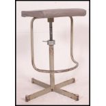 A superb vintage industrial machinists factory stool with adjustable height and unusual footrest.