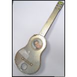 A vintage Elvis related mirror in the shape of a guitar, with notation to base. Wall hanging.