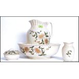 An early 20th century Staffordshire porcelain wash set comprising of jug, basin,