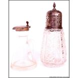 A silver and cut glass hallmarked sugar sifter together with a silver and glass oil bottle.