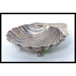 A hallmarked silver shell oyster spoon / server. Decorated in the form of a shell., date letter K.