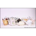 A large collection of teapots to include various shapes and patterns.