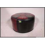 A retro mid century two tone vinyl panel stitched pouffe,