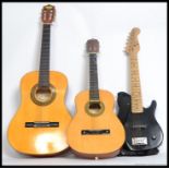 Two acoustic guitars the first being a childs six string along with a three quarter sized six