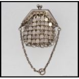 A silver mesh linked penny purse. Unmarked, tests as silver, clasp handle atop with chain.