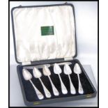 A cased set of six silver plated grapefruit spoons with a grapefruit knife having a hallmarked