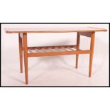 A mid century teak vintage / retro surf board style coffee table complete with magazine rack