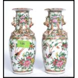 A pair of 19th century Chinese Canton vases of small form.