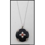 A silver, black glass and bloodstone set ladies pendant and necklace.