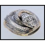 A white metal (marked ' sterling ' for silver ) antique style vesta in the form of a coiled snake.