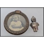 A continental silver metal early 20th century babies rattle along with a small circular silver