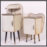 A near pair of white vinyl mid century bedside cabinets, having raised shelf,