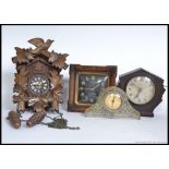 A collection of clocks to include a cuckoo clock, Bakelite Ferranti,
