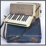 A cased vintage Hohner Alpina Accordion complete with the original case