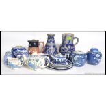 A collection of blue and white ceramics to include willow pattern teapot,