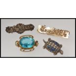 A collection of 4 brooches to include a gold and mother of pearl forget me not brooch,