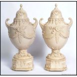 A pair of Staffordshire stoneware Weedon urns with
swag detailing H 45cm W 22cm