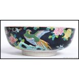 A Chinese famille rose fruit bowl with black ground having floral sprays,