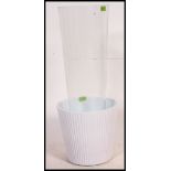 A large floor standing glass vase  / planter by Ikea together with a ceramic planter.