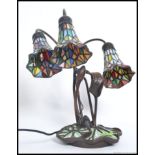 A 20th century Tiffany style lamp having decorative base with stained glass half moon shade.