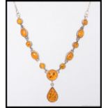 A 20th century silver and amber pendant necklace chain together with a matching bracelet