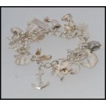 A good silver charm bracelet with multiple charms etc  ( see illustrations )