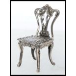 A well detailed 925 white metal / silver miniature Chippendale style chair. 11.