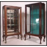 A Queen Anne's china display cabinet in mahogany with glass shelves.