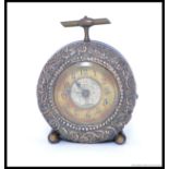 A silver faced ( dated 1907 ) mounted circular strut bedside timepiece,