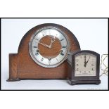 A mid century Smiths oak cased mantle clock along with a smaller Smiths Bakelite electric clock.