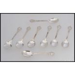 A set of 8 silver hallmarked spoons having chased scrolled bowls and handles.