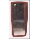 A retro 1970's atomic style teak wall mirror.