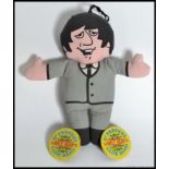 A vintage Paul McCartney Beatles fabric doll along with a pair of Sgt Peppers Lonely Hearts Club