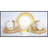 A vintage Foley china part tea service, each decorated with yellow lines and florals.