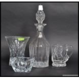 A collection of cut glass / crystal items to include a heavy decanter, vase, vessel and dish.