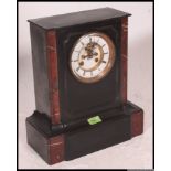 A Victorian black slate and rouge marble mantle clock of architectural form,