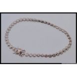 A 925 silver designer CZ set tennis bracelet. Length 17cms. Weight 8g.