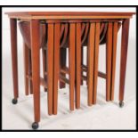 A 1970's retro teak nest of graduating tables,