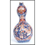 An late 19th century Imari pattern double fluted gourd vase.